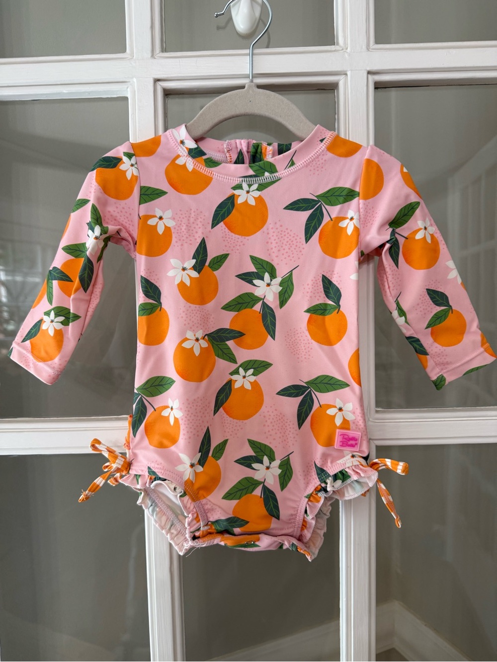 Ruffle Butts Pink Swimsuit with Orange Fruit Print